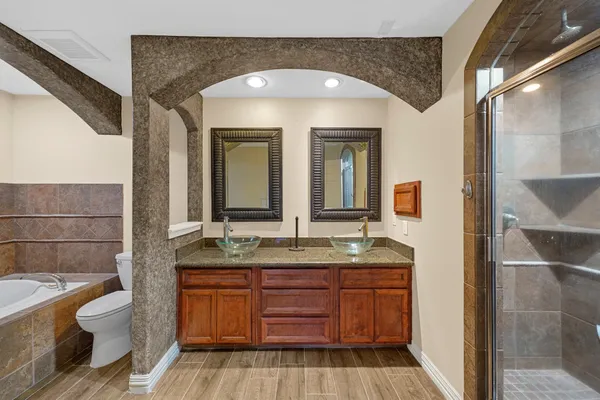 a bathroom with a granite countertop bathtub and a sink