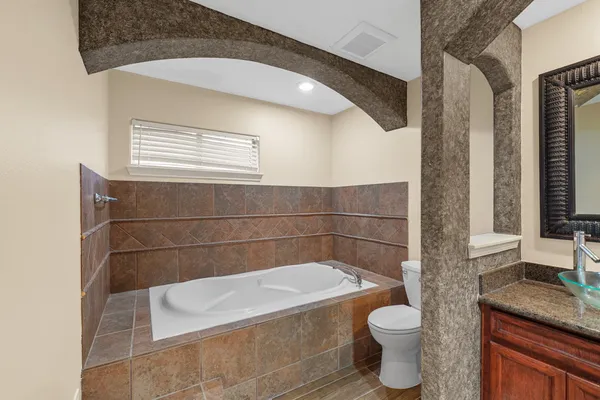 a bathroom with double vanity and a mirror