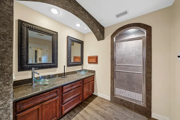 a kitchen with stainless steel appliances granite countertop a refrigerator and wooden cabinets