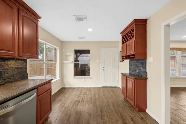 a kitchen with stainless steel appliances granite countertop a refrigerator and a stove top oven