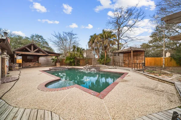 a view of a house with swimming pool and sitting area