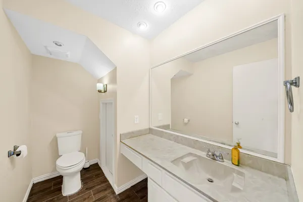 a view of empty room with wooden floor and fireplace