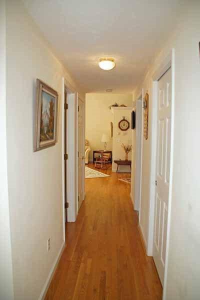 8 Dundee Circle Harwich, MA 02645 - Photo 15 of 28 a view of a hallway with bathroom and wooden floor