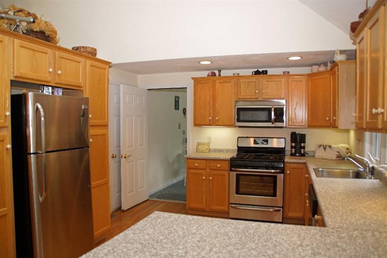 8 Dundee Circle Harwich, MA 02645 - Photo 18 of 28 a kitchen with granite countertop a refrigerator stove and microwave