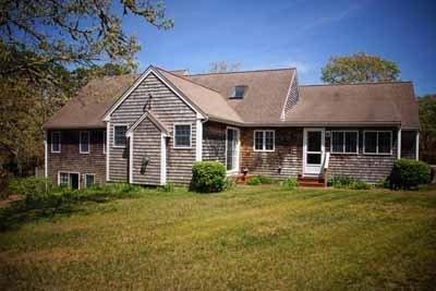 8 Dundee Circle Harwich, MA 02645 - Photo 2 of 28 a front view of a house with a garden and porch