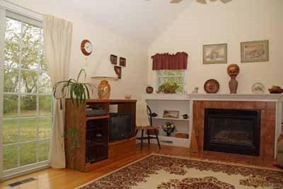 8 Dundee Circle Harwich, MA 02645 - Photo 21 of 28 a living room with furniture and a fireplace