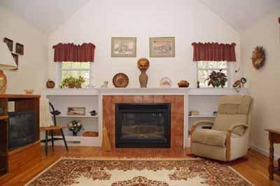 8 Dundee Circle Harwich, MA 02645 - Photo 22 of 28 a living room with furniture and a fireplace