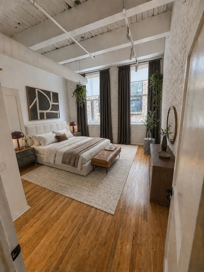 312 North May Street, Unit 4H Chicago, IL 60607 - Photo 8 of 13 a bedroom with a large bed a flat tv screen and a dresser