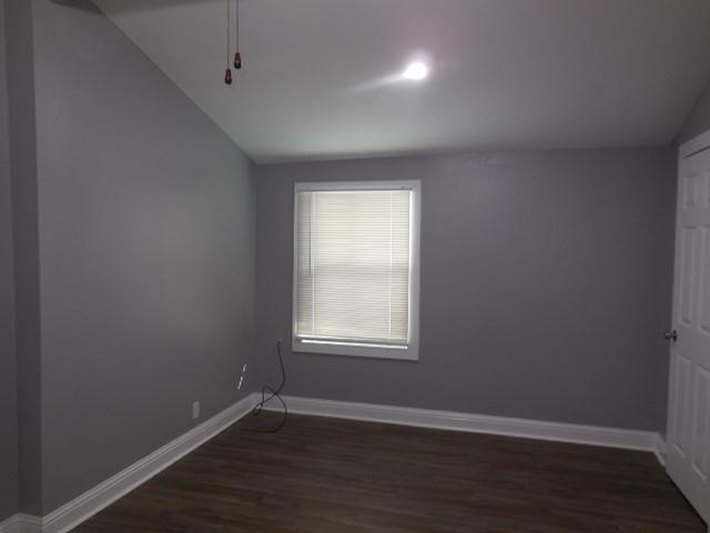 127 Stonewall-Preston Road Stonewall, LA 71078 - Photo 13 of 19 Unfurnished room with baseboards, lofted ceiling, and dark wood-style floors