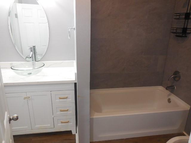 127 Stonewall-Preston Road Stonewall, LA 71078 - Photo 10 of 19 Full bath featuring tub / shower combination, wood finished floors, and vanity