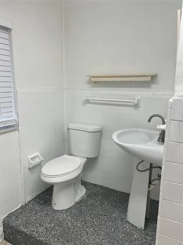 a bathroom with a sink toilet and a mirror