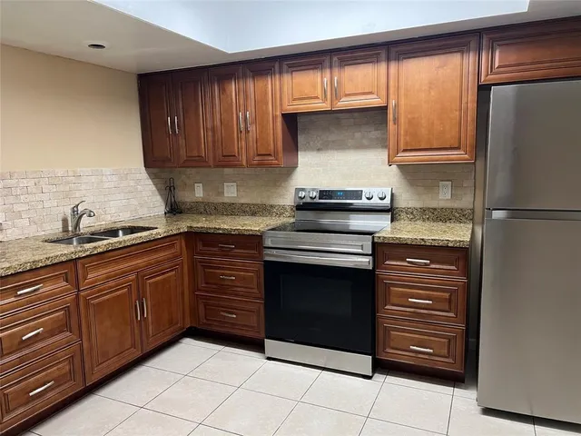a kitchen with granite countertop stainless steel appliances and cabinets