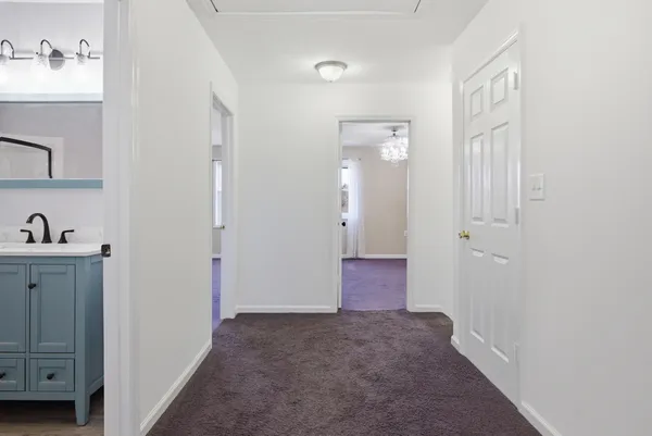 an empty room with a ceiling fan and a window