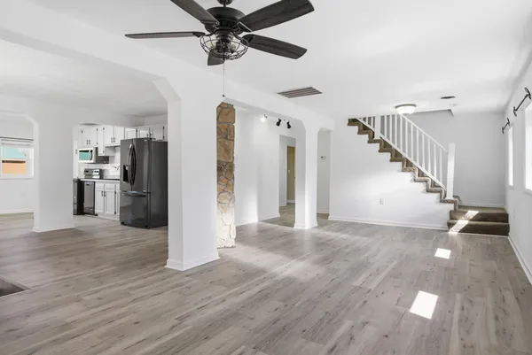 a view of empty room with wooden floor