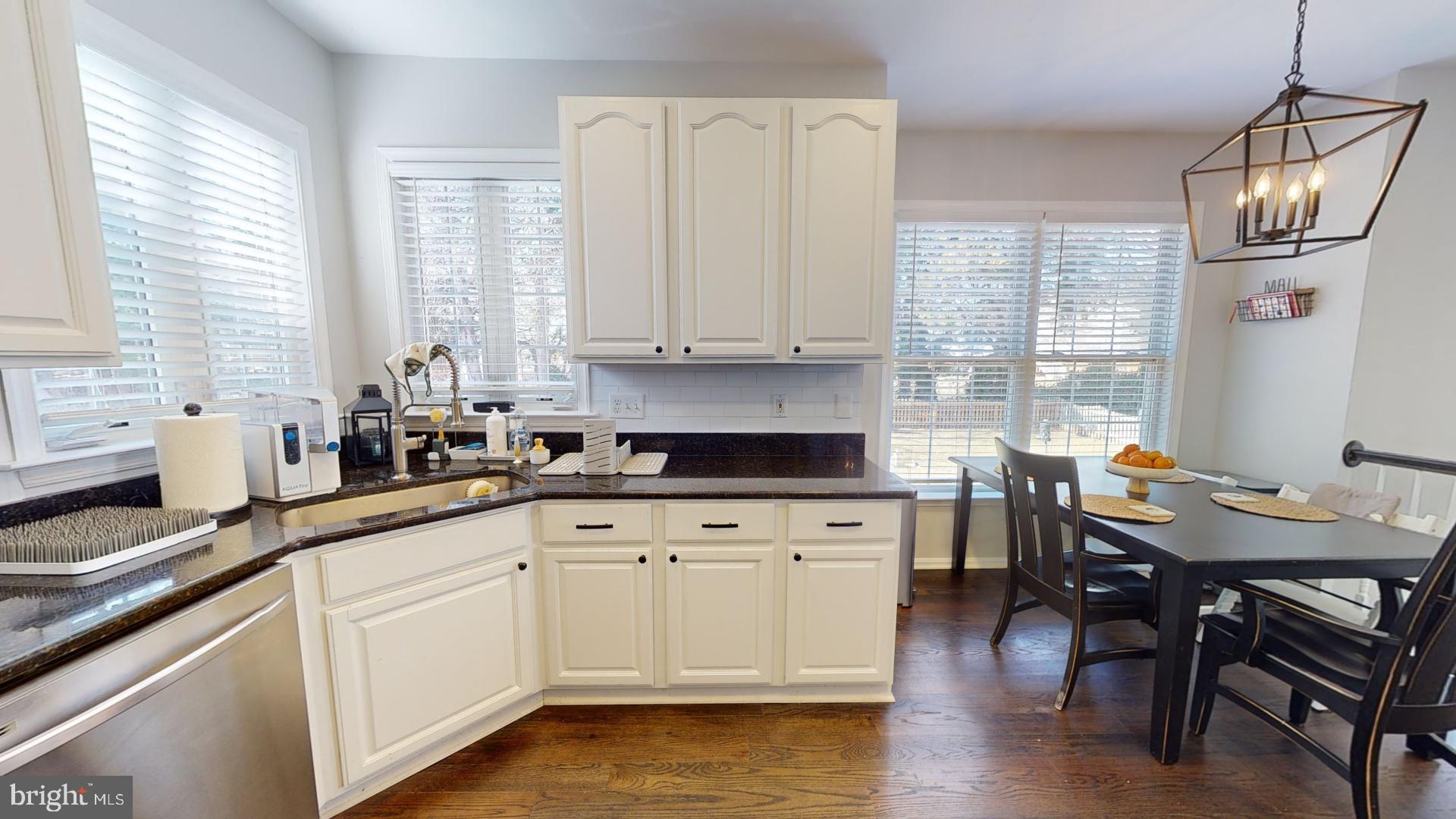 25405 Chicama Drive Chantilly, VA 20152 - Photo 12 of 44 a kitchen with white cabinets and sink