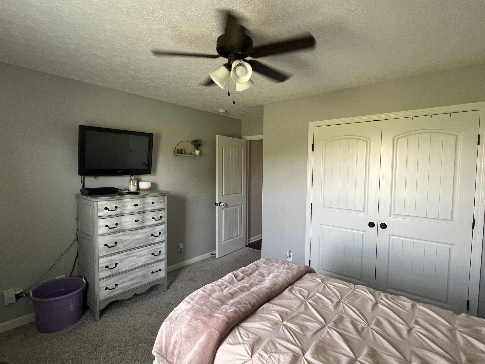 546 Corinth Road Portland, TN 37148 - Photo 25 of 37 a bedroom with a bed and a flat tv screen on dresser