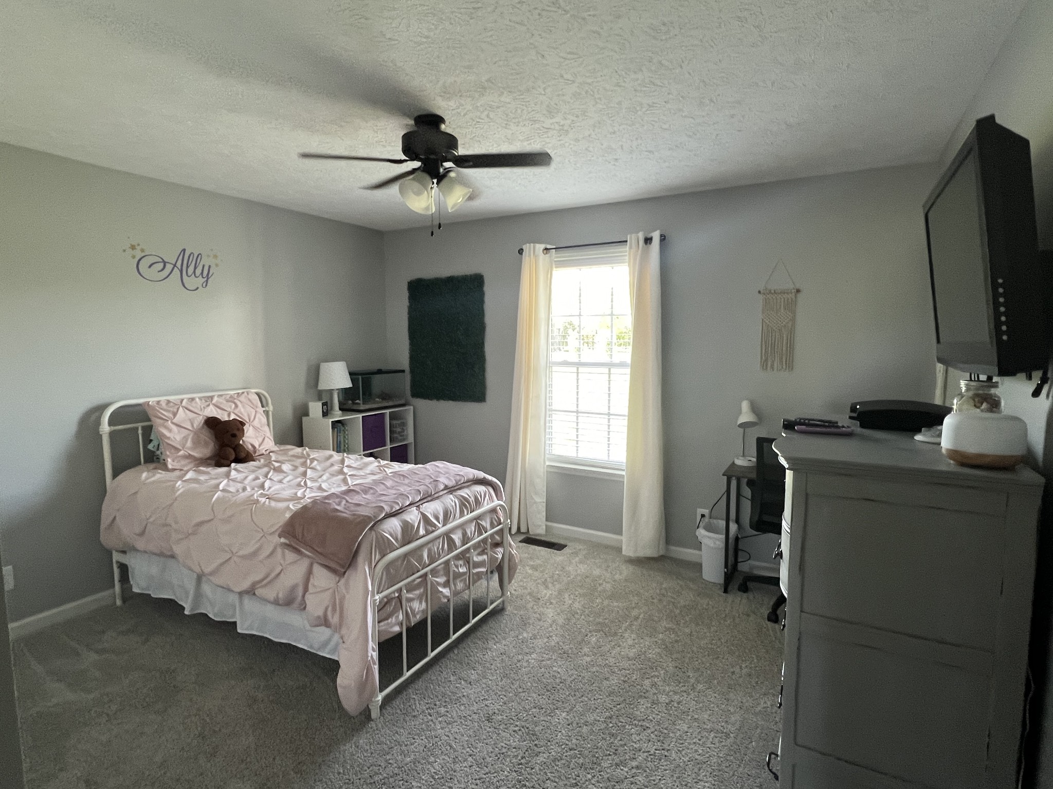 546 Corinth Road Portland, TN 37148 - Photo 26 of 37 a bedroom with a bed and a flat tv screen on the dresser
