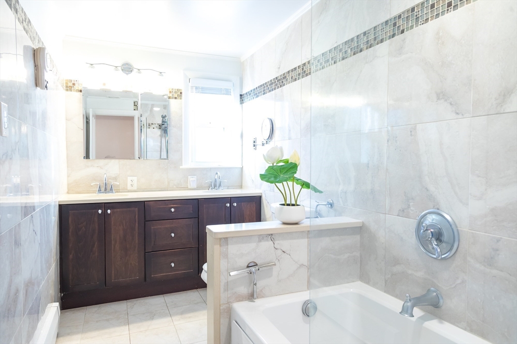 15 Higgins Road Marblehead, MA 01945 - Photo 6 of 26 a bathroom with a sink and a mirror