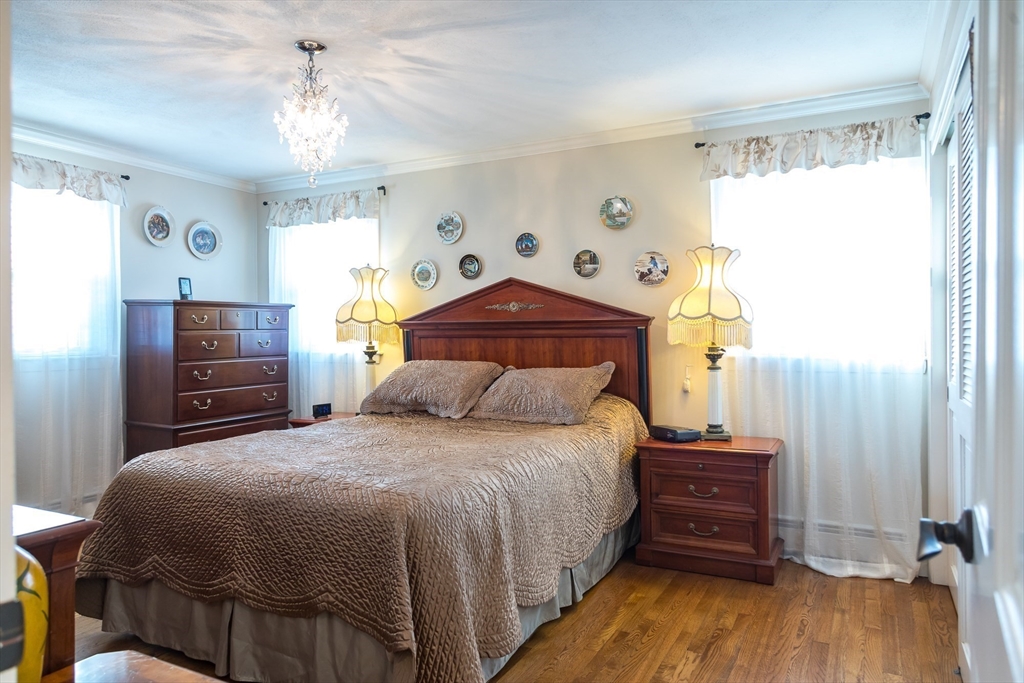 15 Higgins Road Marblehead, MA 01945 - Photo 9 of 26 a bedroom with a bed and wooden floor