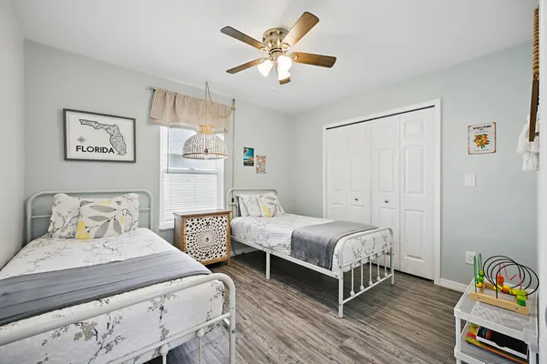 a bedroom with a bed and a chandelier