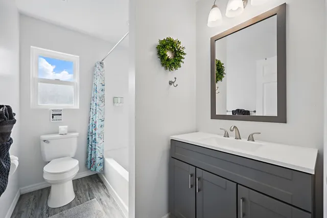 a bathroom with a toilet sink and mirror
