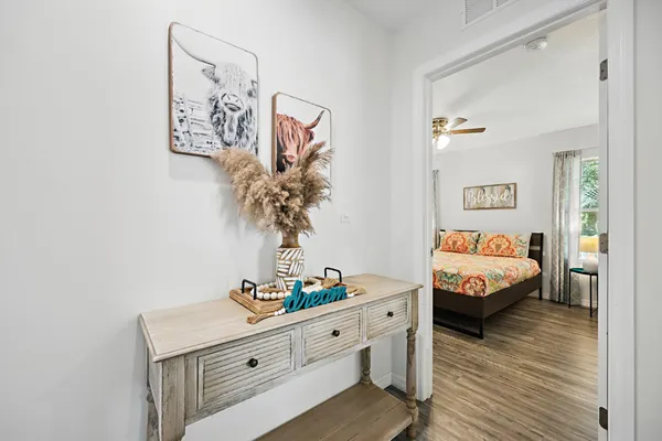 a living room with furniture and wooden floor