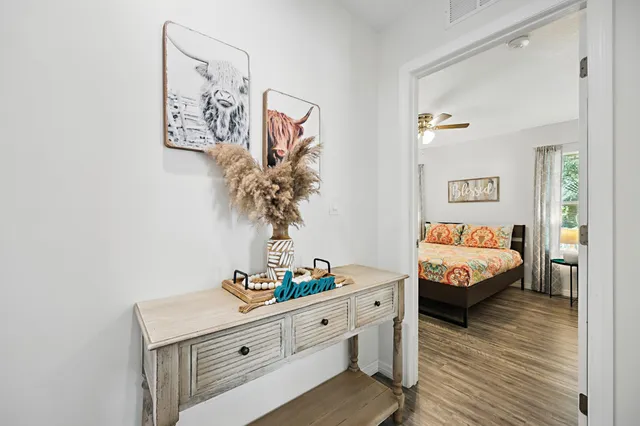 a living room with furniture and wooden floor