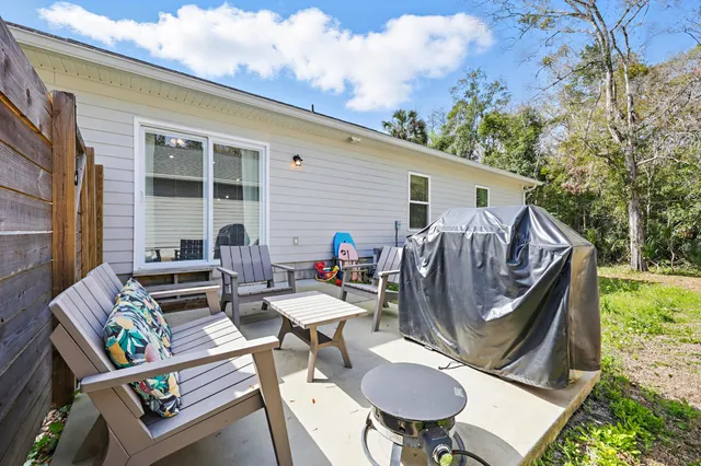 a view of outdoor sitting area with furniture and wooden floor