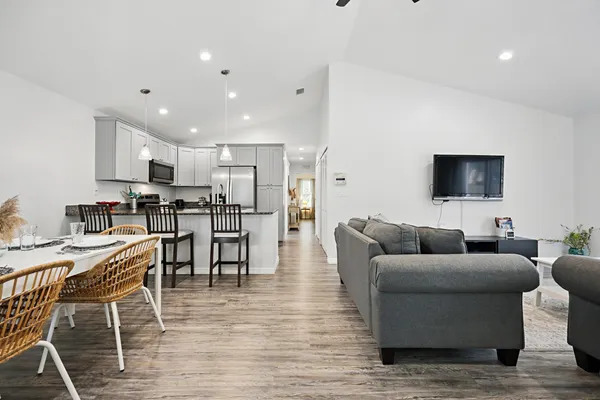a living room with furniture wooden floor and a flat screen tv