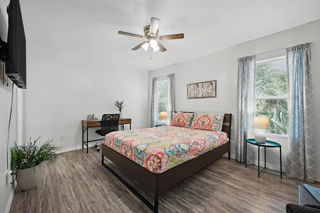 a bed room with a bed window and a flat screen tv