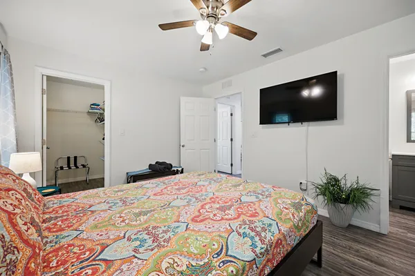 a bedroom with a bed and a flat screen tv