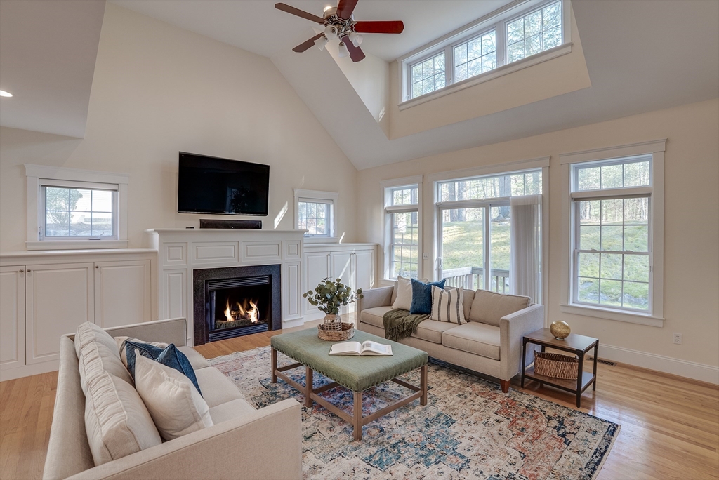 a living room with furniture a rug and a flat screen tv