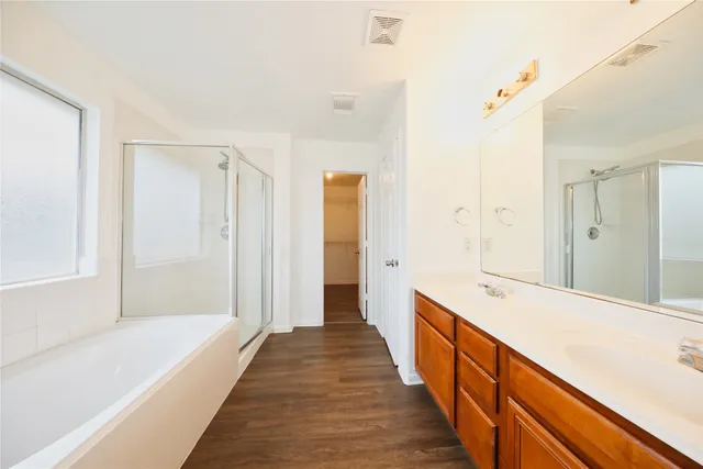 a hallway with wooden floor and chandelier