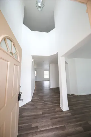 a view of a hallway view with wooden floor and staircase