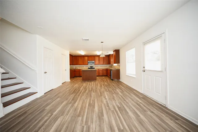 a view of wooden floor and windows in a room