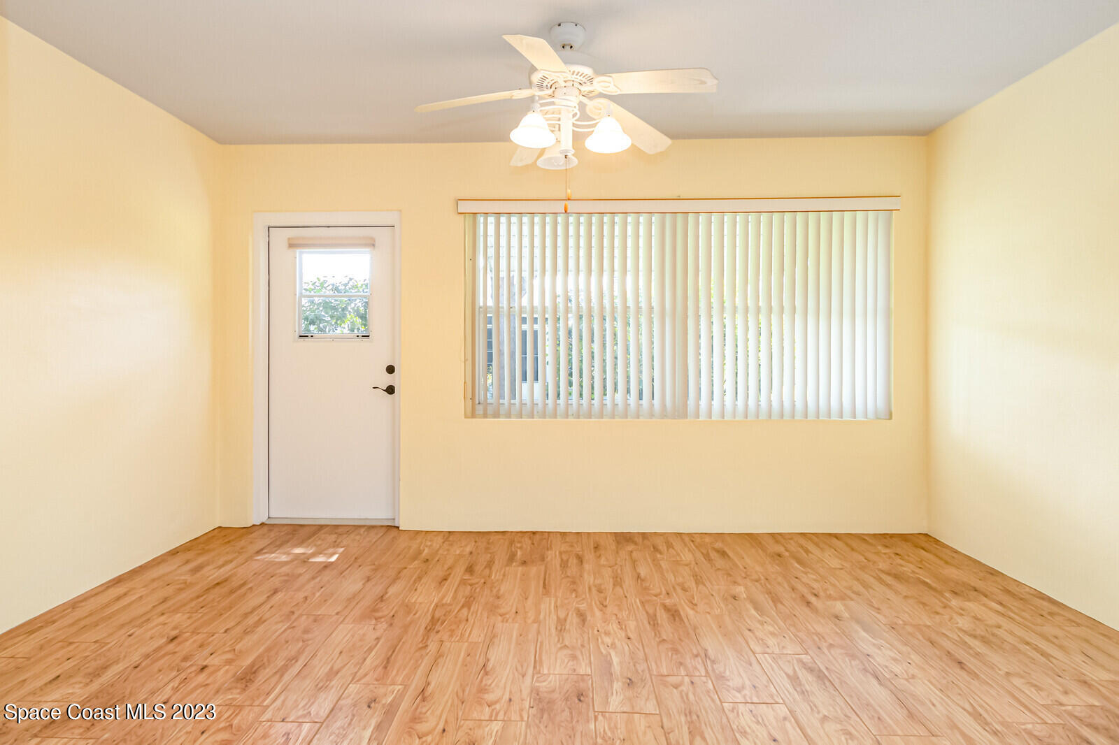 1041 South Fork Circle Melbourne, FL 32901 - Photo 17 of 62 a view of an empty room with wooden floor and a window