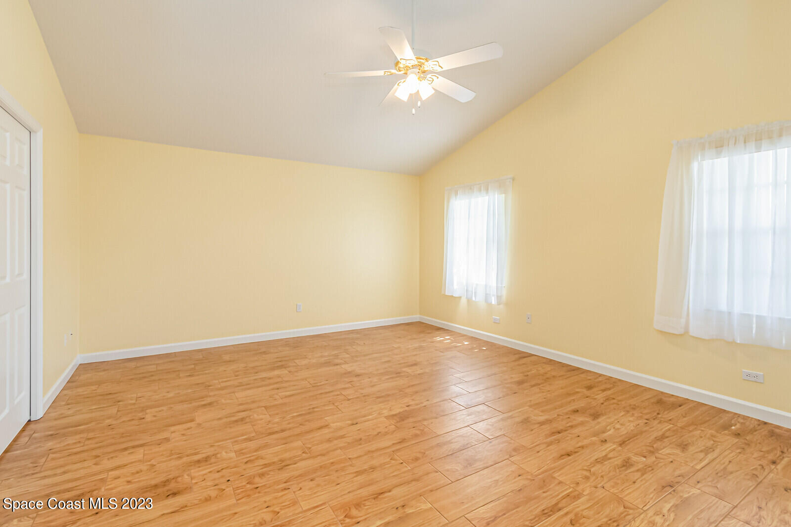 1041 South Fork Circle Melbourne, FL 32901 - Photo 18 of 62 an empty room with a window and a ceiling fan
