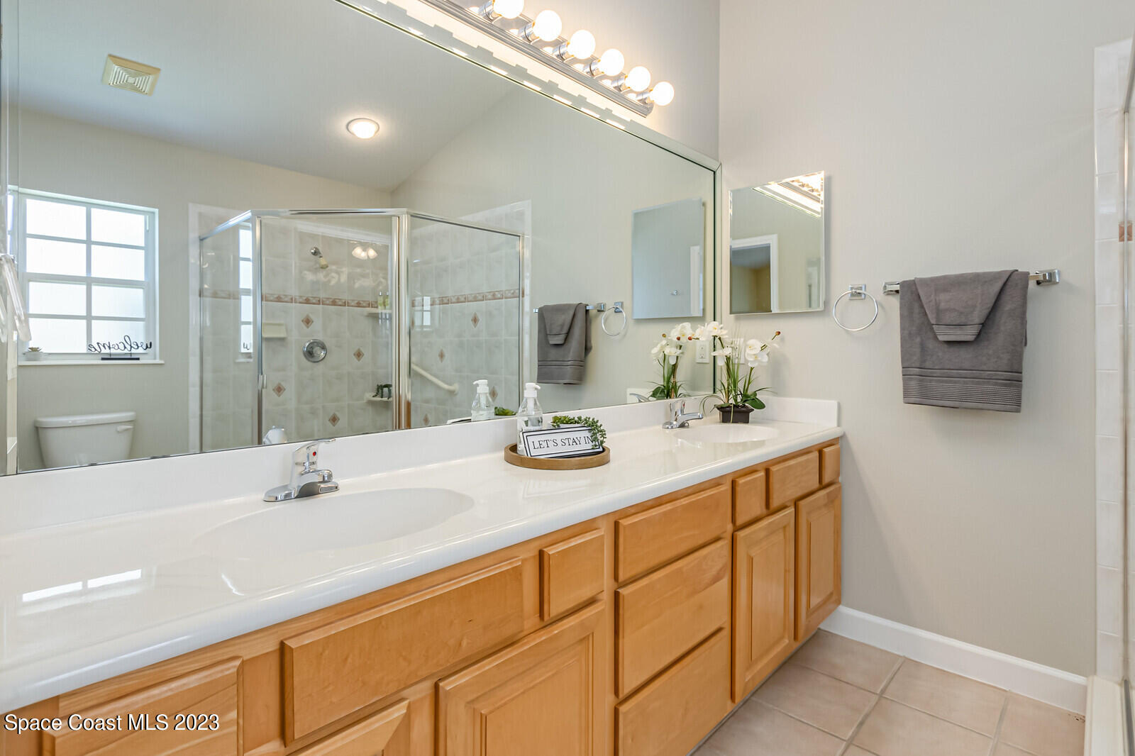 1041 South Fork Circle Melbourne, FL 32901 - Photo 20 of 62 a bathroom with a sink double vanity and a mirror