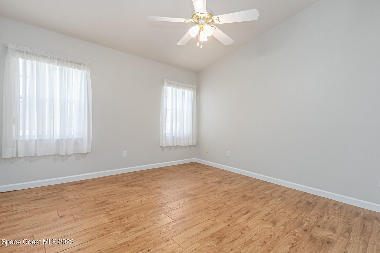 1041 South Fork Circle Melbourne, FL 32901 - Photo 25 of 62 wooden floor in an empty room with a window