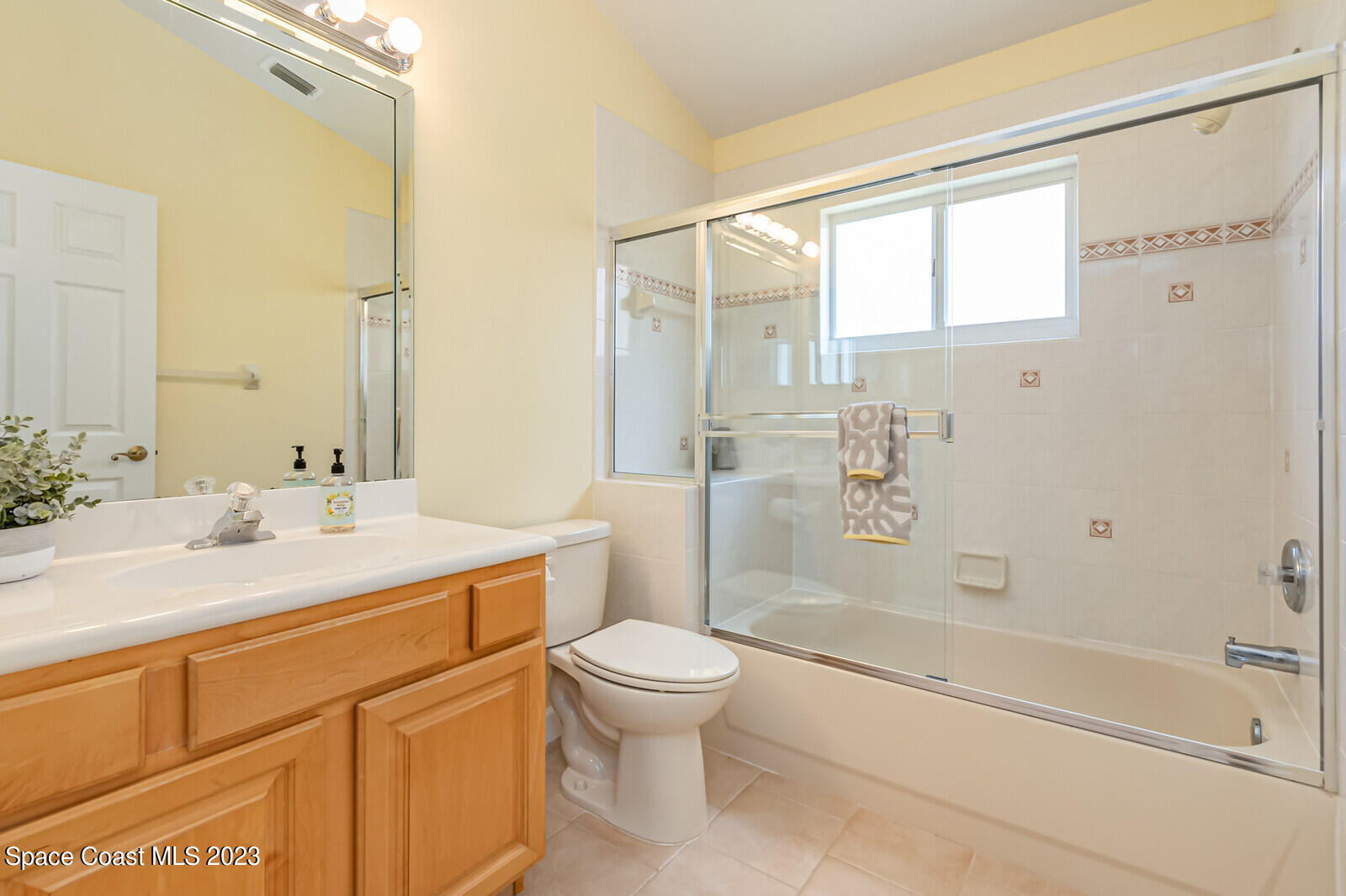 1041 South Fork Circle Melbourne, FL 32901 - Photo 26 of 62 a bathroom with a sink a toilet and a large mirror