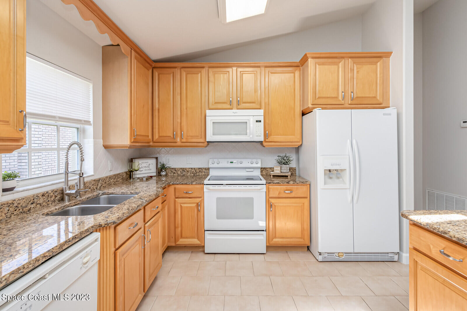 1041 South Fork Circle Melbourne, FL 32901 - Photo 7 of 62 a kitchen with stainless steel appliances granite countertop a stove a sink and a refrigerator