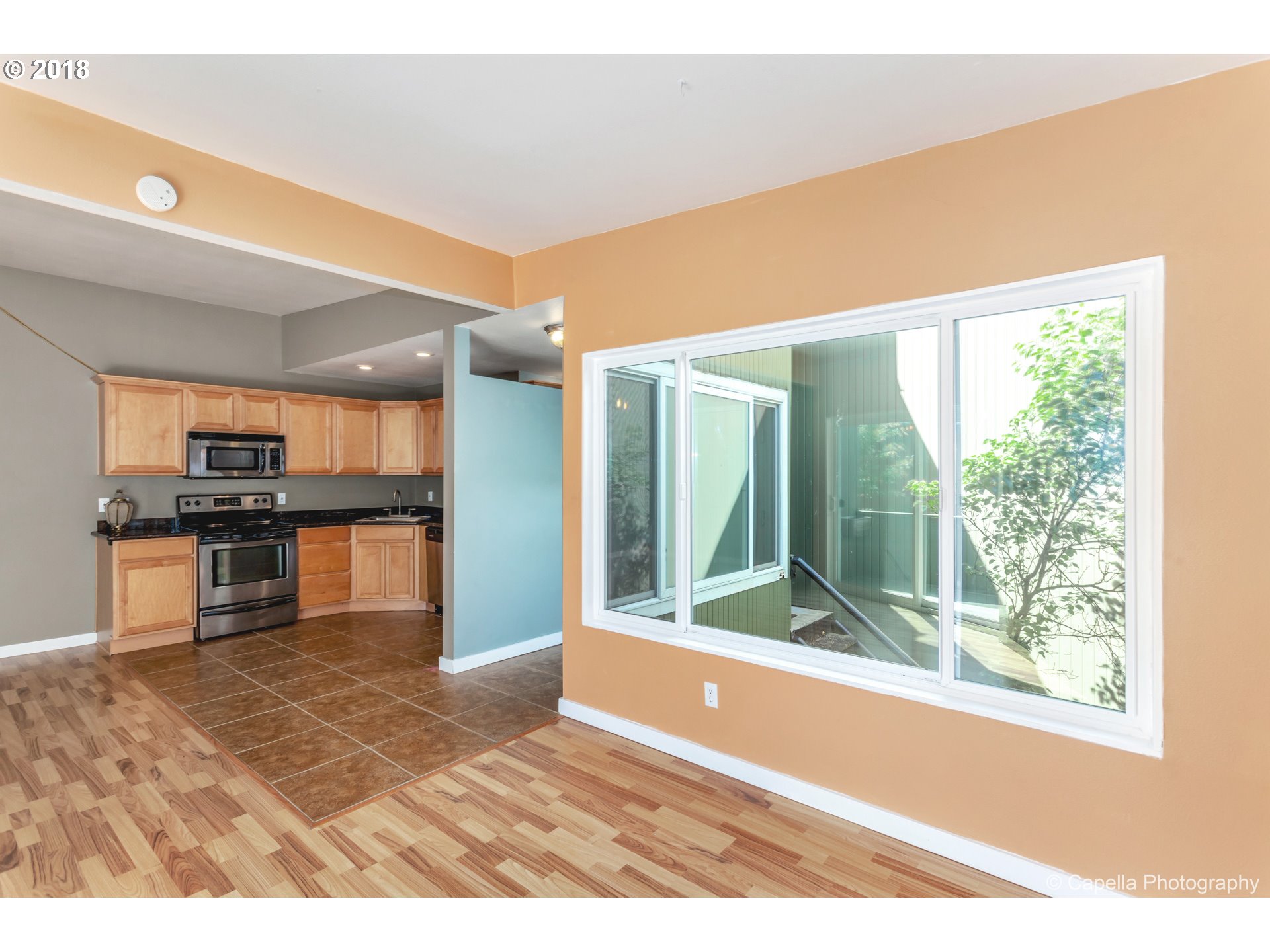 6220 Southwest Capitol Highway, Unit 8 Portland, OR 97239 - Photo 6 of 13 a open kitchen with granite countertop a refrigerator and a sink