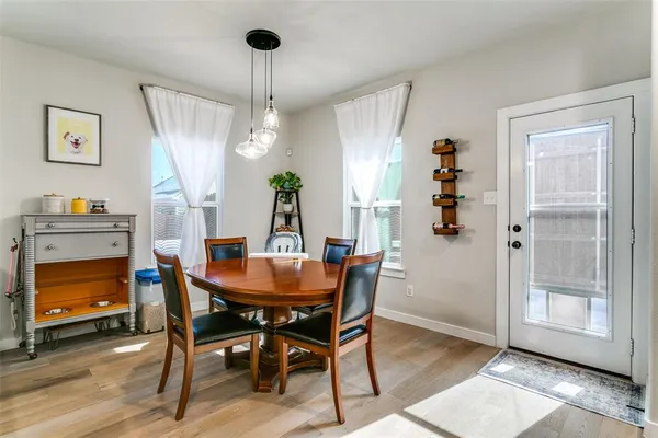 a view of a dining room with furniture and a chandelier