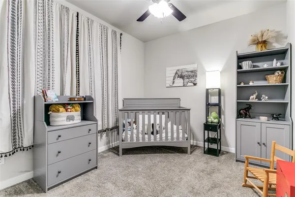a view of a bedroom with furniture and window