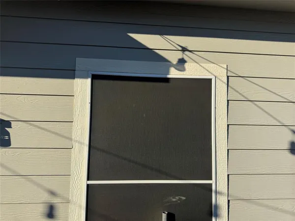 a view of a door and a window of the house