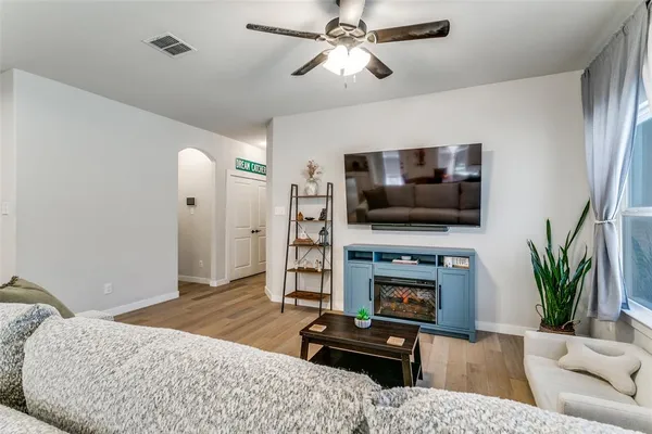 a bedroom with furniture and a flat screen tv
