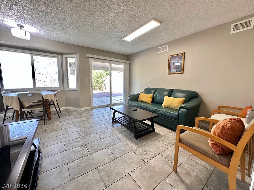 2340 Viewcrest Road Henderson, NV 89014 - Photo 11 of 36 This living space offers a seamless transition to the outdoors through sliding doors.