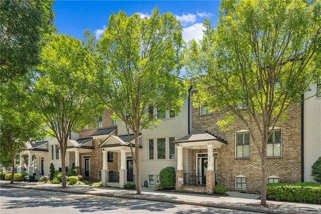 front view of a brick house next to a yard