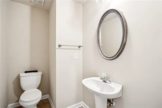 a bathroom with a sink a mirror and a toilet