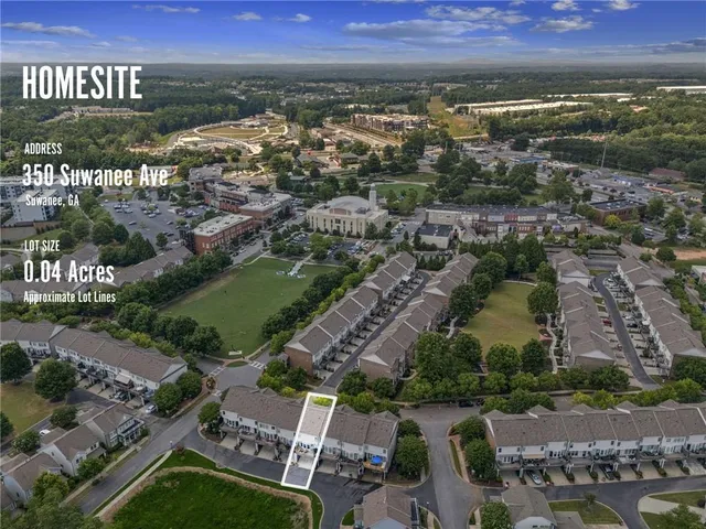 a view of an empty room with chandelier fan and fire place
